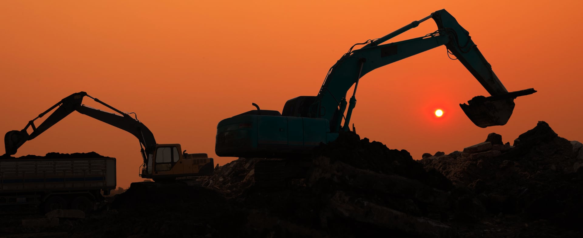 Tractors working at sunset